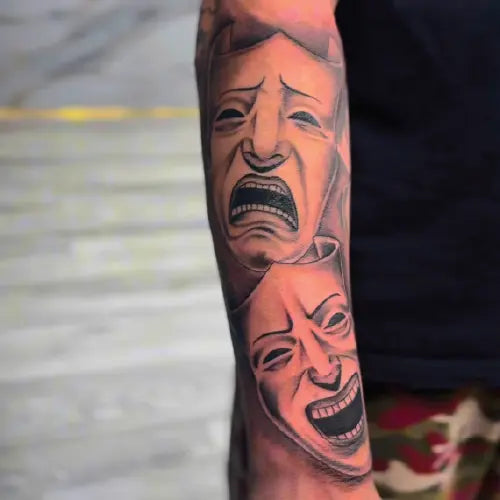 drama masks full arm sleeve tattoo