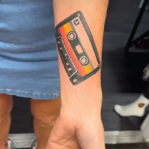old school compact cassette tape forearm tattoo