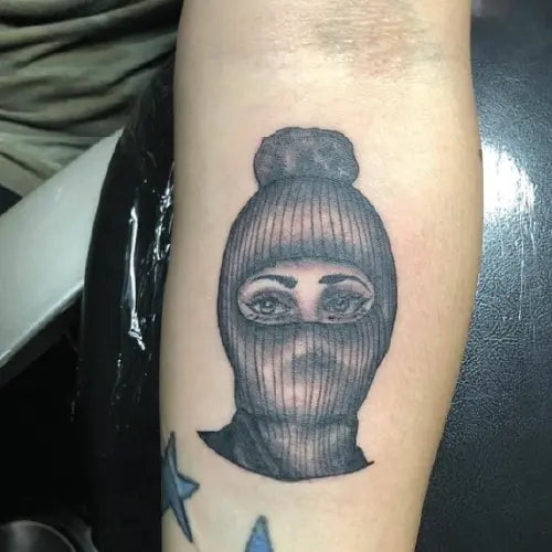 black and grey masked woman tattoo