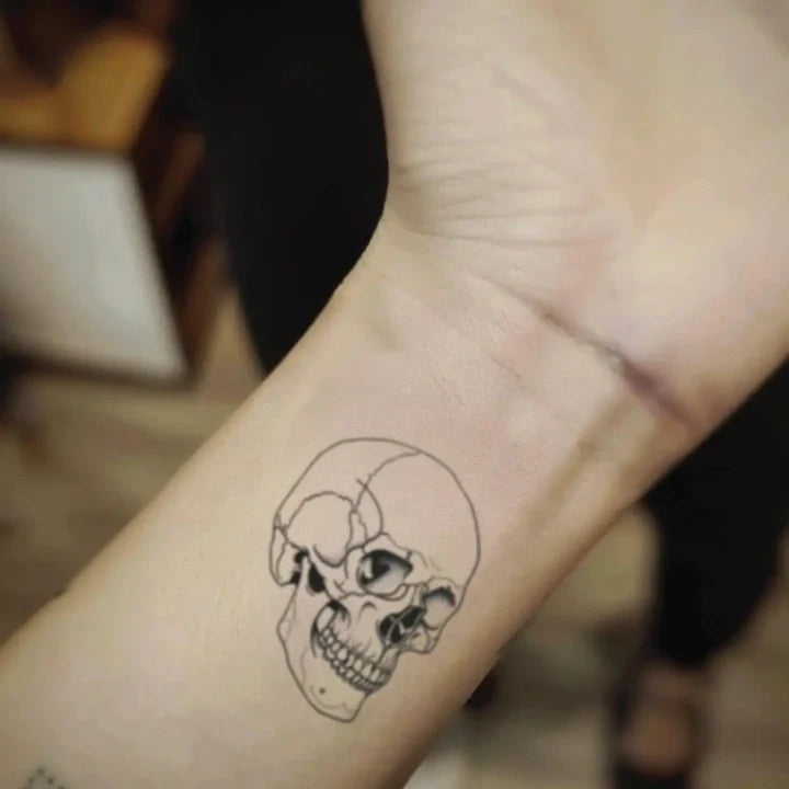 simple skull outline wrist temporary tattoo idea design