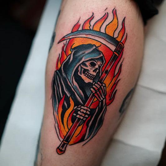 flaming grim reaper tattoo on leg