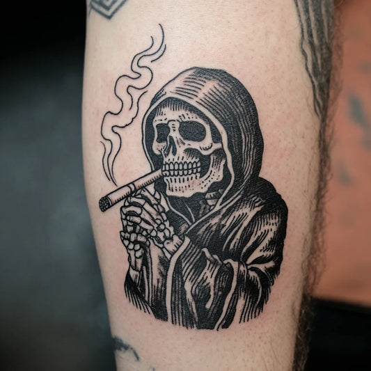 grim reaper cigarette tattoo on forearm