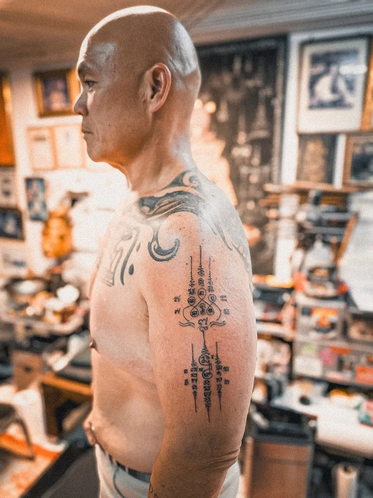 traditional Sak Yant tattoo on man upper arm