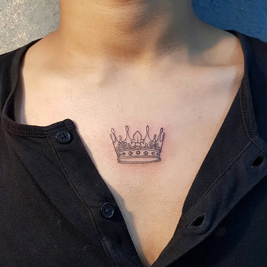 Tiny Black and Grey Crown Tattoo on Women Chest by @snehalquadros
