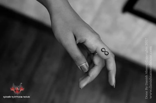 Tiny Black and Grey Infinity Tattoo on Women Finger by @danishtattoozhouse