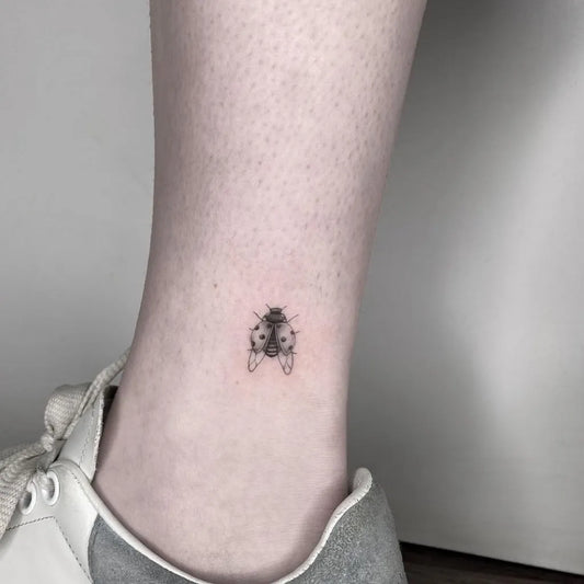 Tiny Black and Grey Ladybug Tattoo on Women Ankle by @sailorstattoomilanobovisa