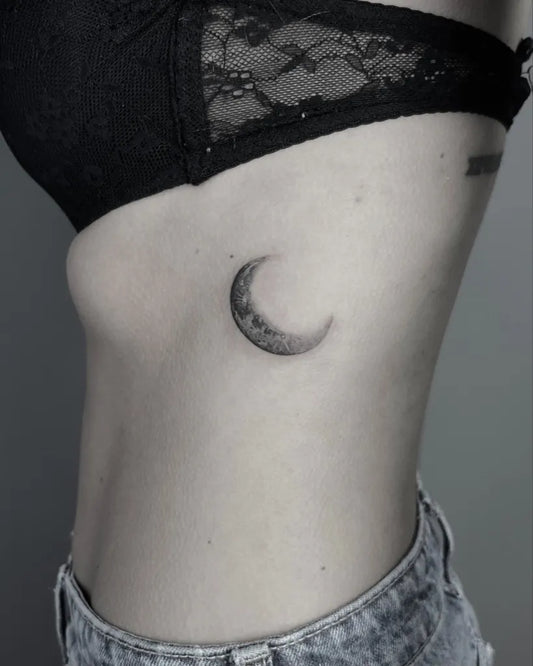 Tiny Black and Grey Moon Tattoo on Women Rib by @elfi_tats