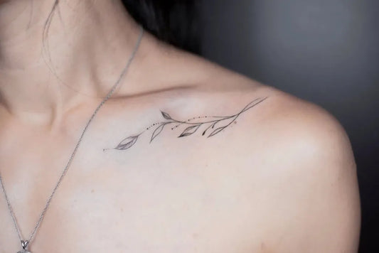 Tiny Black and Grey Olive Branch Tattoo on Women Collarbone by @tattoobysoso