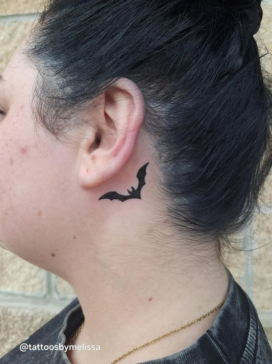 Tiny Blackwork Bat Tattoo on Women Behind the Ear by @electricsirentattoo