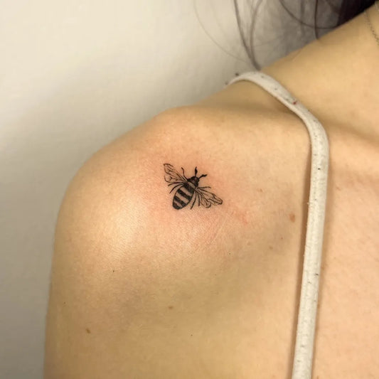 Tiny Blackwork Bee on Women Shoulder Tattoo by @workkslalei