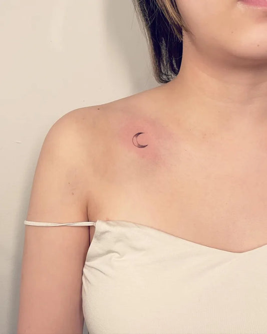 Tiny Blackwork Crescent Moon Tattoo on Women Shoulder by @avivi_ink