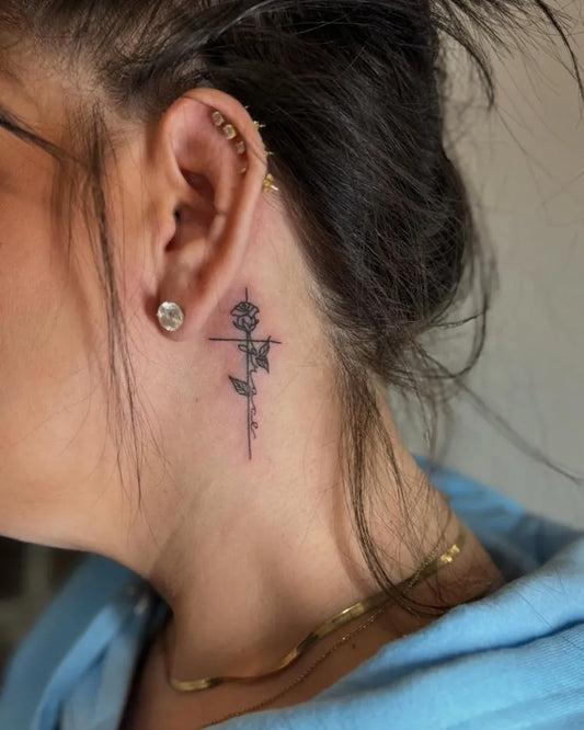 Tiny Blackwork Cross and Rose Tattoo on Women Behind the Ear by @pureblisstinytattoos