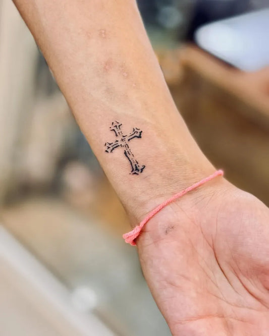 Tiny Blackwork Cross on Women Wrist Tattoo by @bnanatattoo