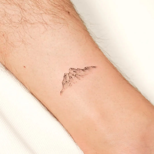 Tiny Blackwork Mountain Tattoo on Men Arm by @cipri.tatt
