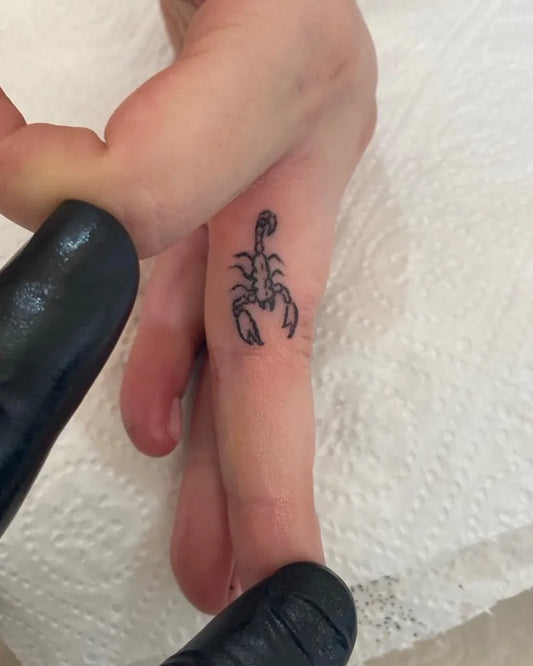 Tiny Blackwork Scorpion on Women Finger Tattoo by @tatouagediabloocasablanca