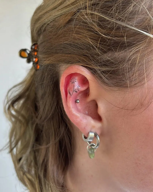 Tiny Blackwork Star and Crescent Tattoo on Women Behind the Ear by @izzypokez