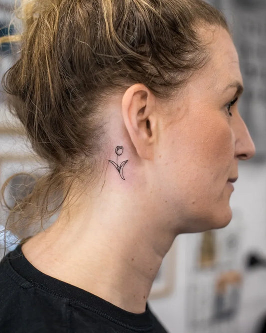 Tiny Blackwork Tulip Tattoo on Women Neck by @annedekkertattoo