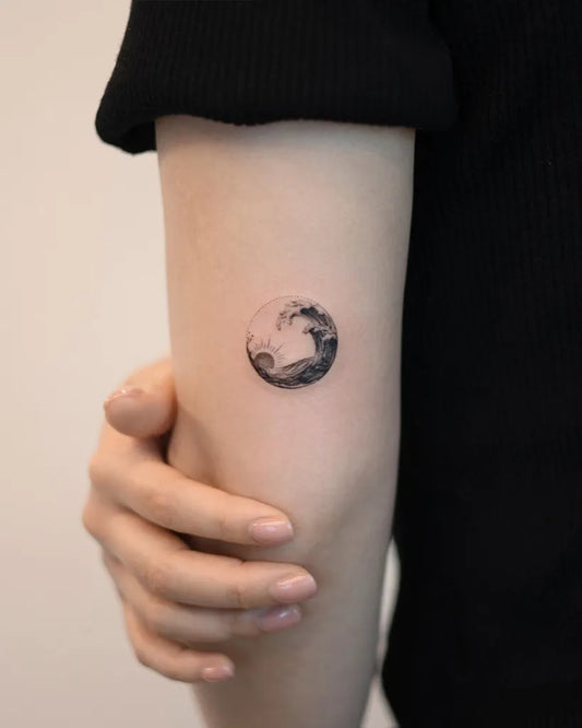 Tiny Blackwork Wave Moon Tattoo on Women Arm by @handitrip