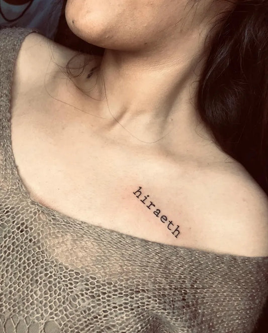Tiny Blackwork Word Tattoo on Women Collarbone by @ajtattoopune