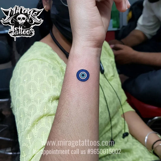 Tiny Dotwork Evil Eye on Women Wrist Tattoo by @miragetattoos