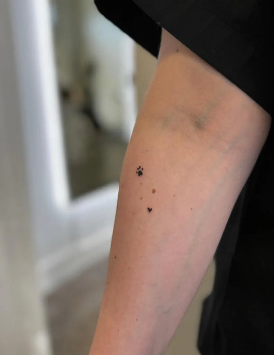 Tiny Dotwork Pawprints on Women Arm Tattoo by @loveyourz.studio