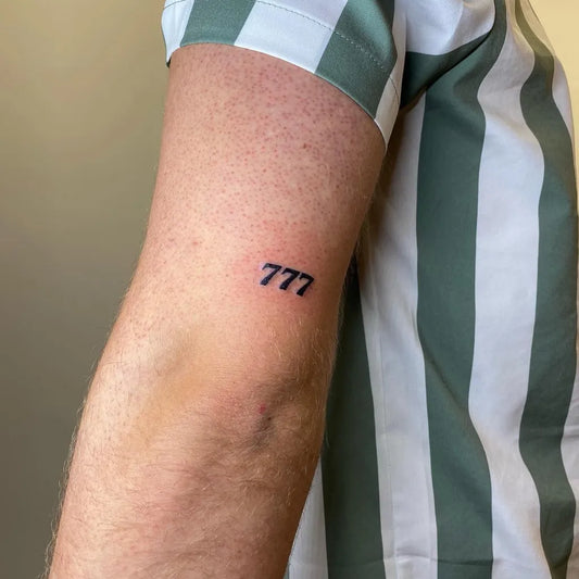 Tiny Fine Line 777 Tattoo on Men Arm by @deliatattoos