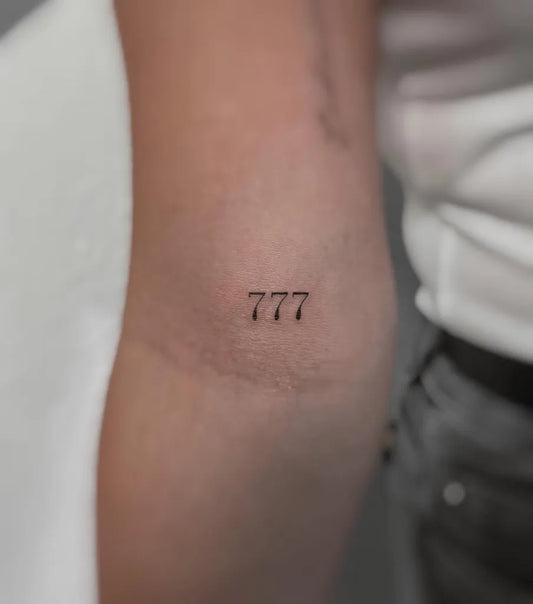 Tiny Fine Line 777 Tattoo on Women Arm by @kiwi.tattoo.ink