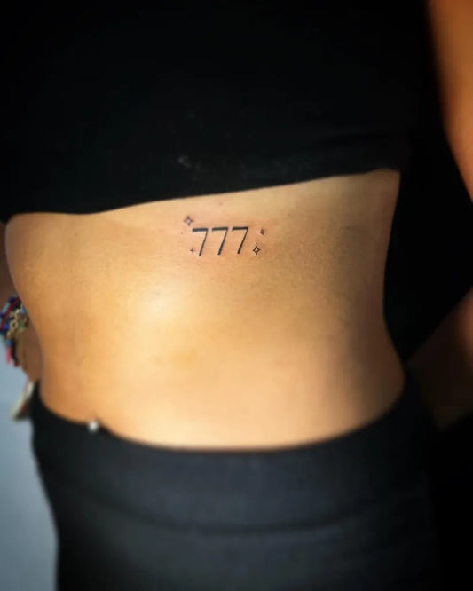 Tiny Fine Line 777 Tattoo on Women Rib by @clockwork.ink