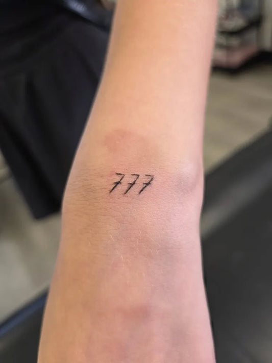 Tiny Fine Line 777 Tattoo on Women Wrist by @icy_beautyy_by_keyla