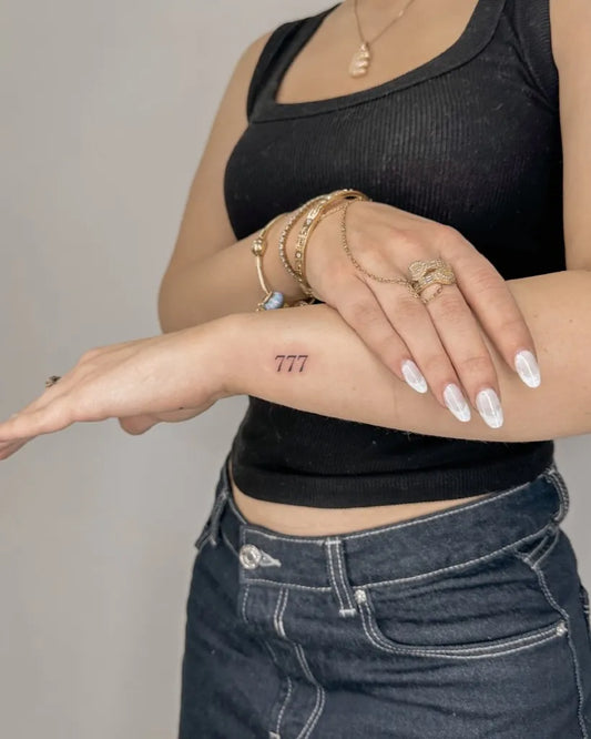 Tiny Fine Line 777 Tattoo on Women Wrist by @mallorcatattoofine