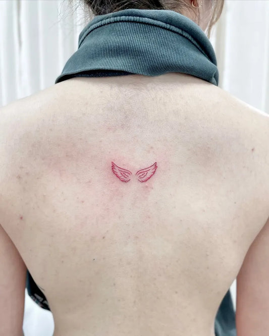 Tiny Fine Line Angel Wings Tattoo on Women Back by @tattoo_thailand