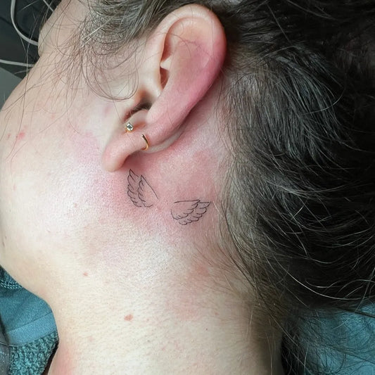 Tiny Fine Line Angel Wings Tattoo on Women Ear by @01tattoo