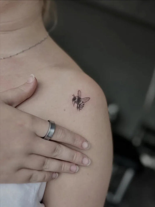 Tiny Fine Line Bee on Women Shoulder Tattoo by @medinatattoos_