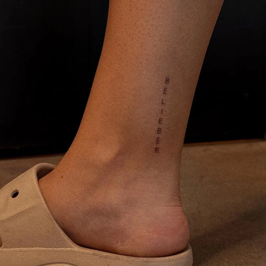 Tiny Fine Line Believe Word on Women Ankle Tattoo by @emotionally.tatted
