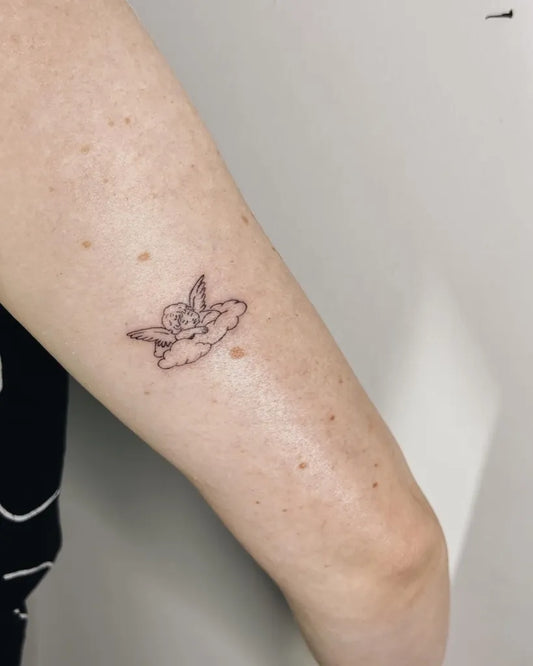 Tiny Fine Line Cherub and Cloud Tattoo on Women Arm by @sarah.mei.tattoo