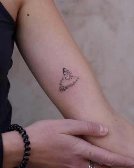 Tiny Fine Line Cloud Tattoo on Women Arm by @mickey.ontheclouds