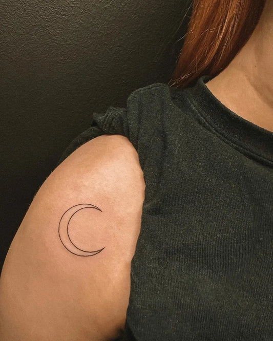 Tiny Fine Line Crescent Moon Tattoo on Women Shoulder by @hybridink.helsinki