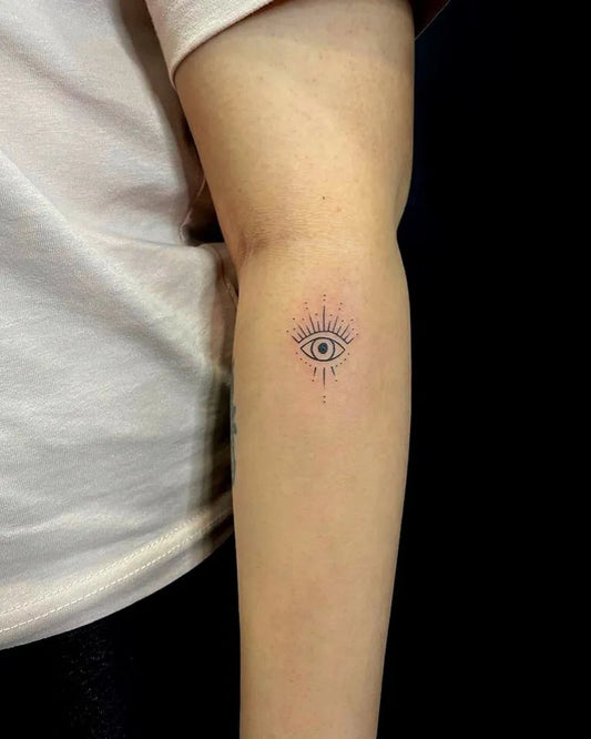 Tiny Fine Line Eye with Rays on Women Arm Tattoo by @havelitattoo