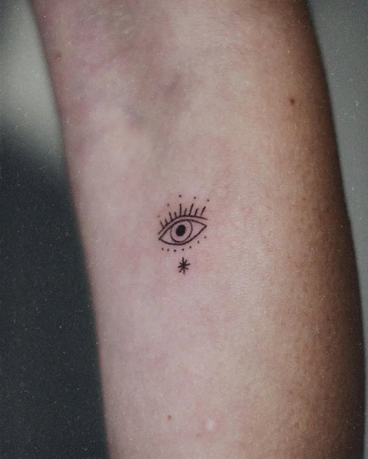 Tiny Fine Line Eye with Stars on Women Arm Tattoo by @sera.sacli