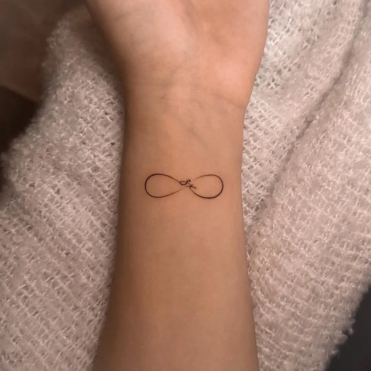 Tiny Fine Line Infinity Symbol Tattoo on Women Wrist by @timi_inlayerink
