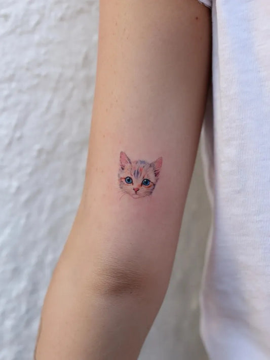 Tiny Fine Line Kitten Face on Women Upper Arm Tattoo by @finelinetattoo_korea