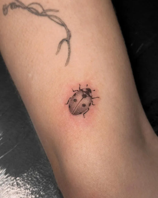 Tiny Fine Line Ladybug Tattoo on Women Ankle by @rachkatrina