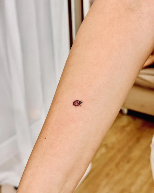 Tiny Fine Line Ladybug Tattoo on Women Forearm by @bnanatattoo