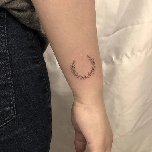 Tiny Fine Line Laurel Wreath Tattoo on Women Wrist by @tattoobychang