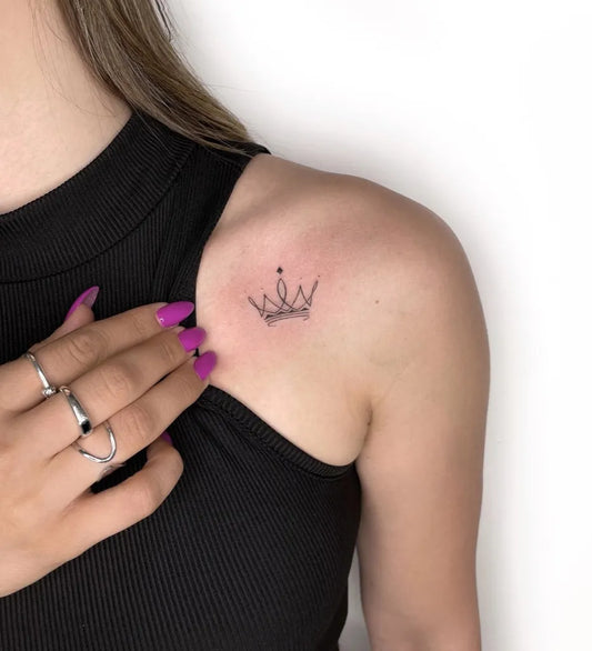 Tiny Fine Line Minimalist Crown Tattoo on Women Shoulder by @yam_tattoo