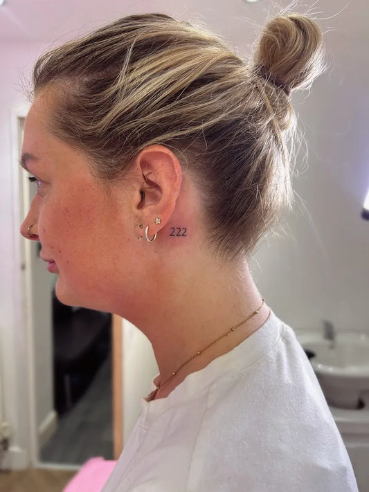 Tiny Fine Line Number Tattoo on Women Behind the Ear by @tinytatswigan