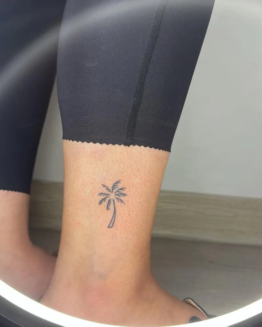 Tiny Fine Line Palm Tree Tattoo on Women Ankle by @hanin_tatoo