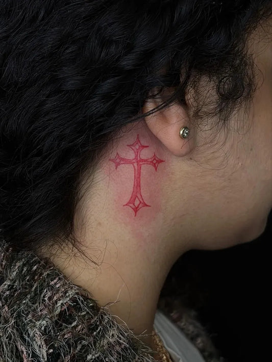 Tiny Fine Line Red Celtic Cross Tattoo on Women Behind the Ear by @acbeauty.ink