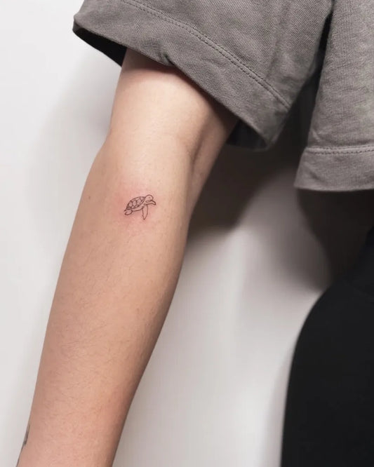 Tiny Fine Line Sea Turtle Tattoo on Women Arm by @kayyang.tattoo