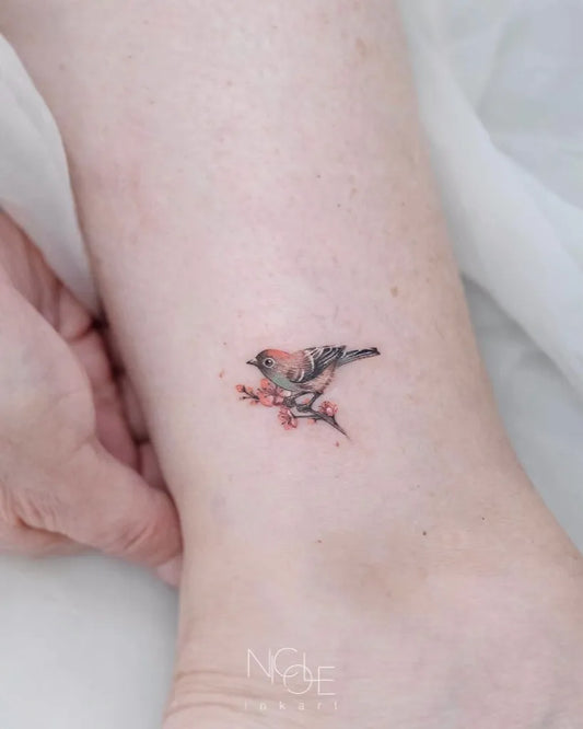 Tiny Fine Line Sparrow with Cherry Blossom Tattoo on Women Ankle by @nicole_inkart